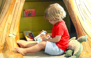 Child reading book at Louisiana Children's Museum
